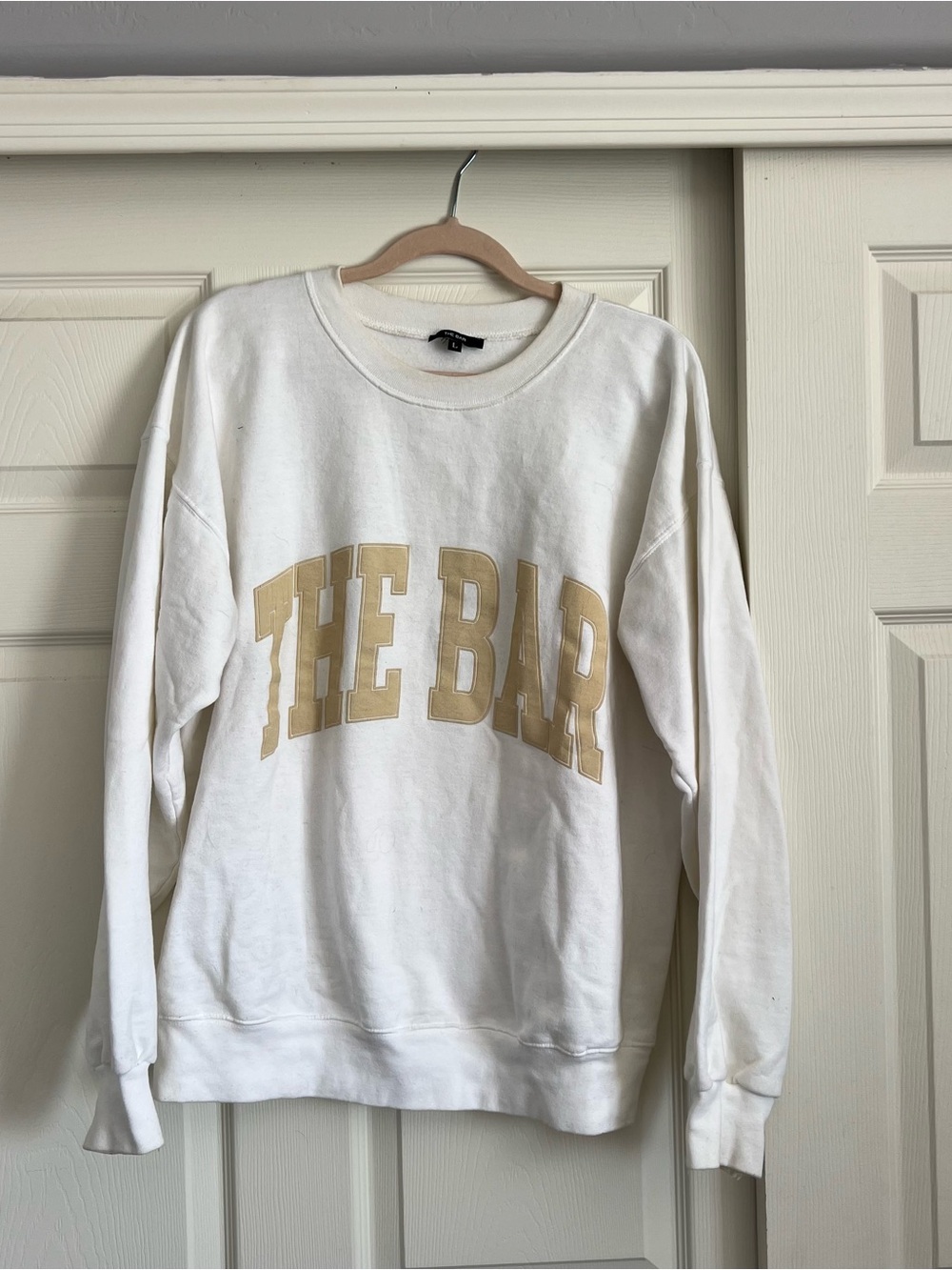 The Bar White Crewneck Sweatshirt with Gold Arch Logo